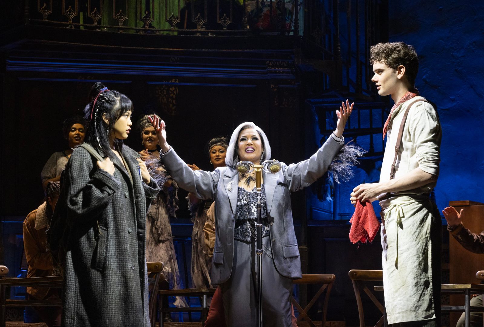 Abigail Adriano as Eurydice, Christine Anu as Hermes and Noah Mullins as Orpheus in Hadestown.
