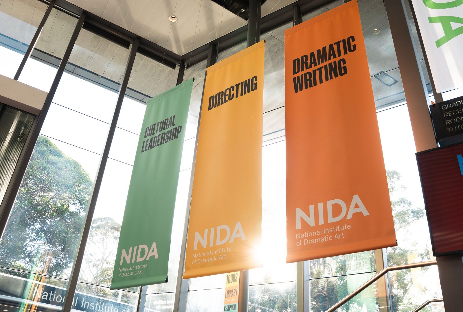 Colourful banners hanging up in a foyer.