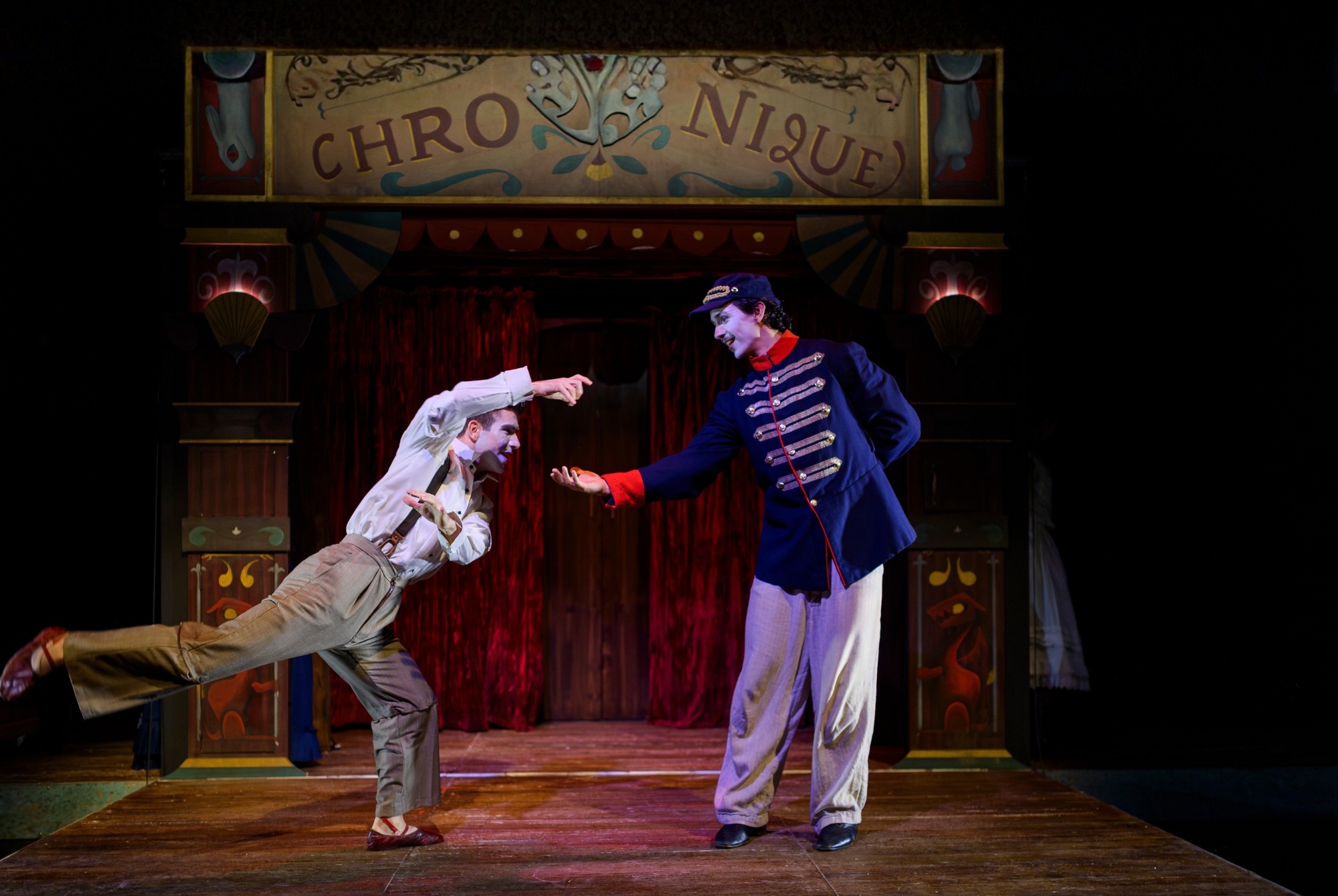 Two performers on stage exchanging hands