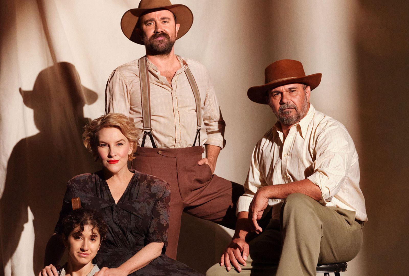 Four actors in period clothing.