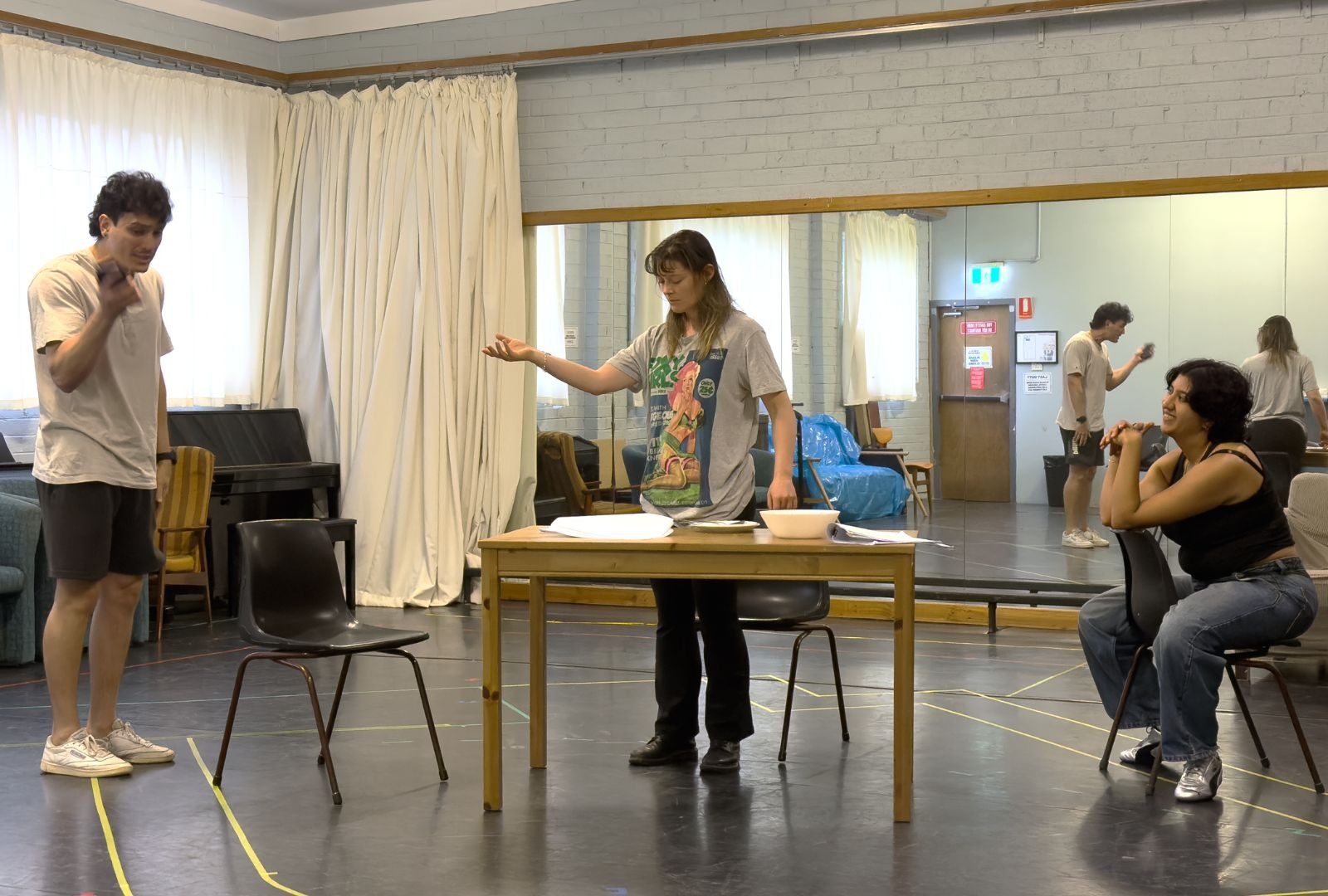 Three people rehearsing a play.